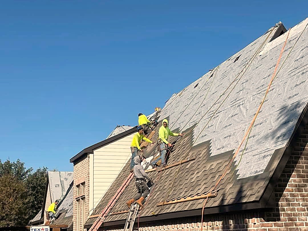 A crew shingling a steep gable over underlayment