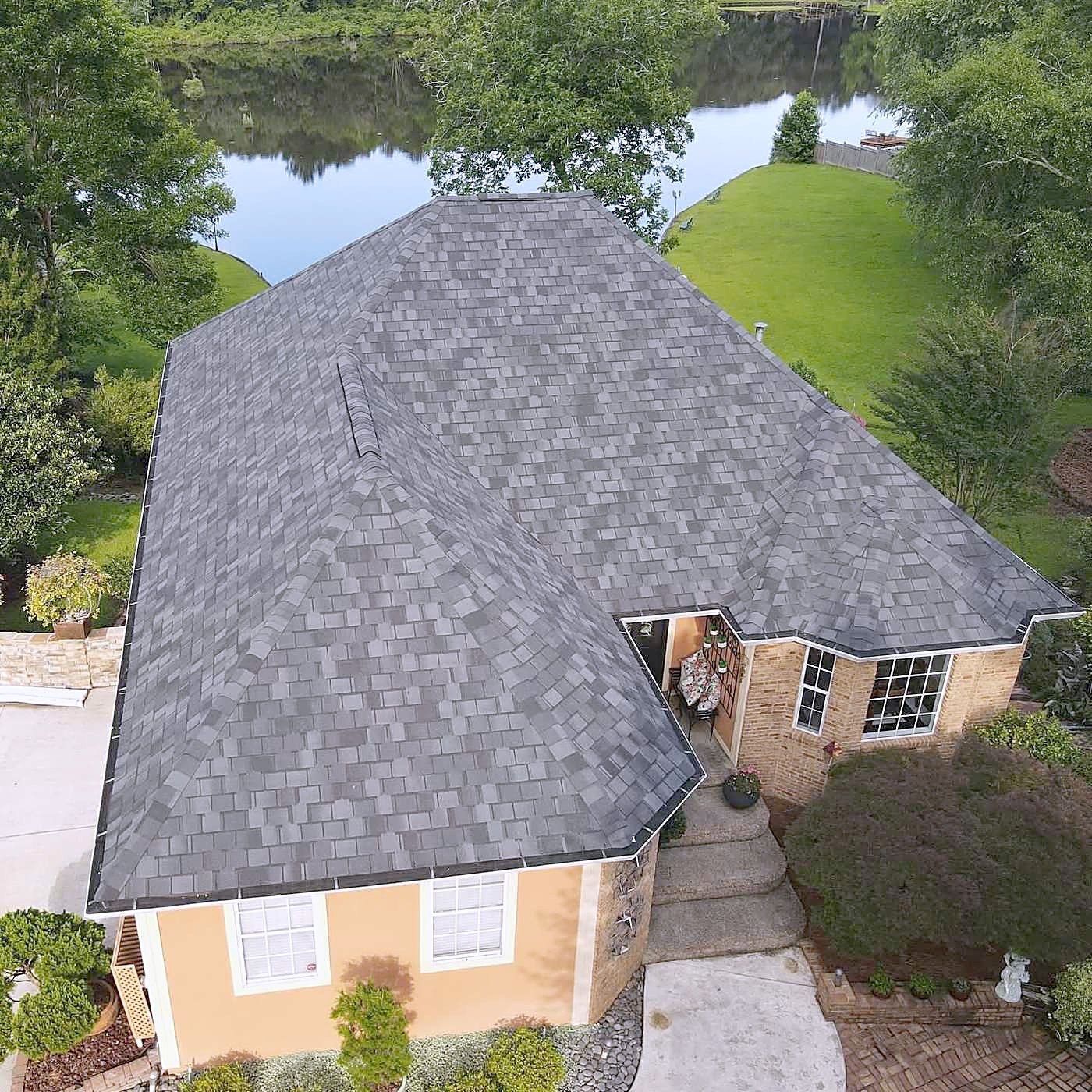 A finished shingle roof on a house by the water