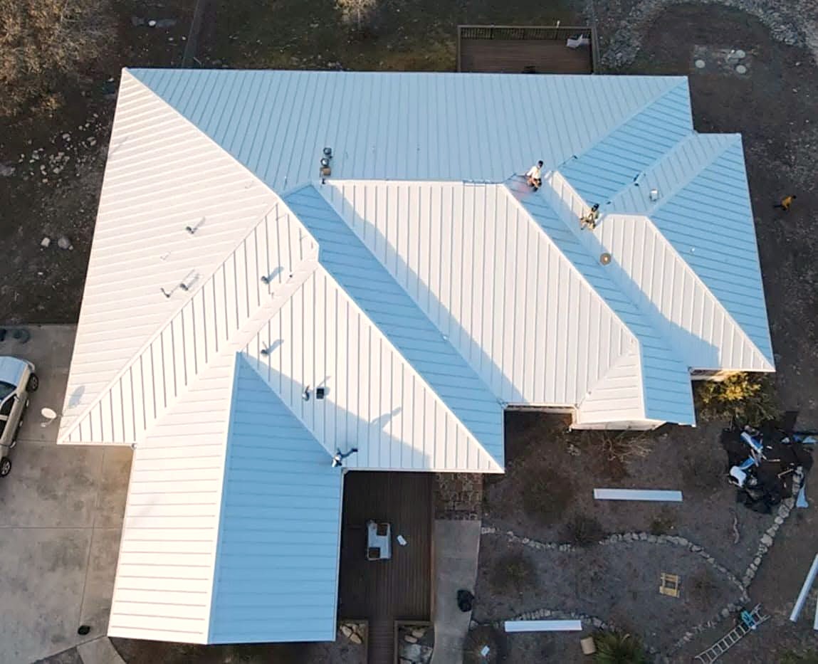 A white standing seam metal roof seen from directly above